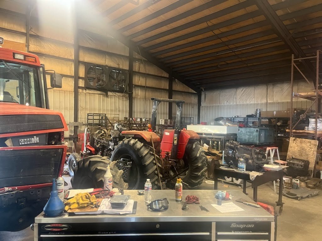 Farm tractor undergoing repair in workshop